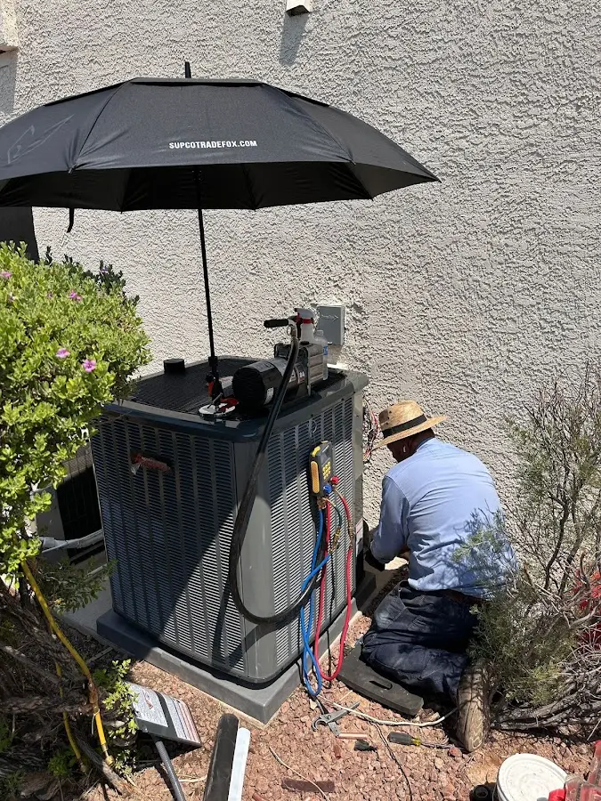 HVAC technician performing outdoor AC maintenance in Parkland
